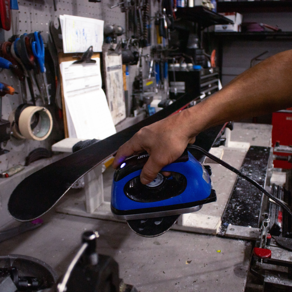 A pair of skis getting waxed